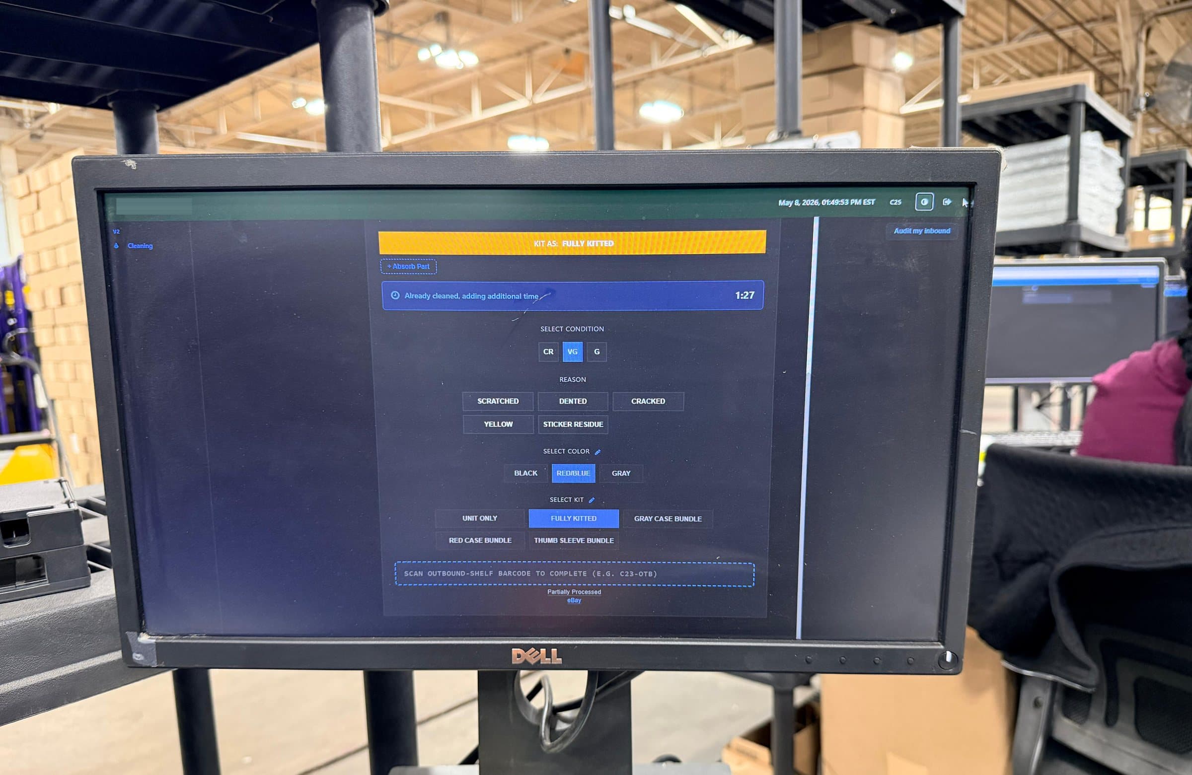 A cleaning station monitor on the warehouse floor running the production interface